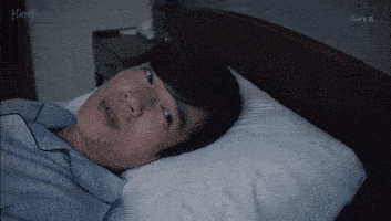 a man is laying on a bed with a white pillow and the word herp on the bottom right