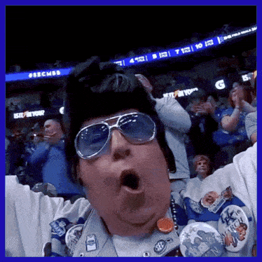 a man wearing sunglasses and a hat with a badge that says march on it