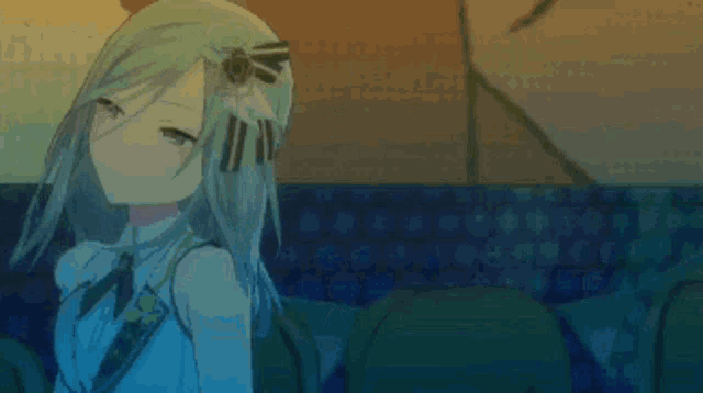 a girl with long blonde hair is sitting in a chair with her arm up .