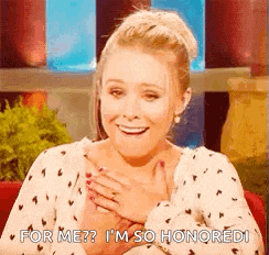 a woman is smiling with her hands on her chest and says `` for me ? i 'm so honored '' .