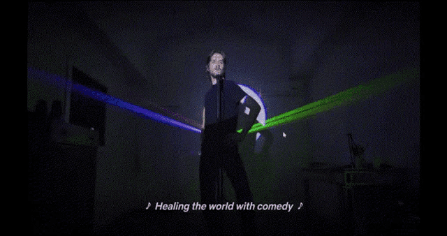 a man is dancing in front of a screen that says making a literal difference metaphorically