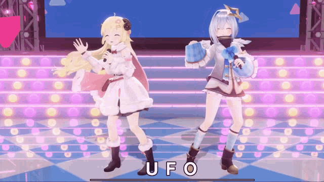 two anime girls are dancing on a stage and the word ufo is on the bottom of the screen