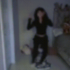 a blurred image of a person standing in front of a mirror