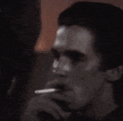 a close up of a man 's face with his hand behind his head