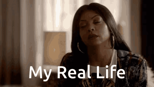 a woman is sitting on a couch with her eyes closed and the words " my real life " behind her