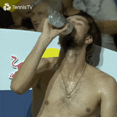 a shirtless man drinking from a bottle with tennis tv written on the bottom