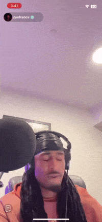 a man wearing headphones and a headband is recording a song on a phone