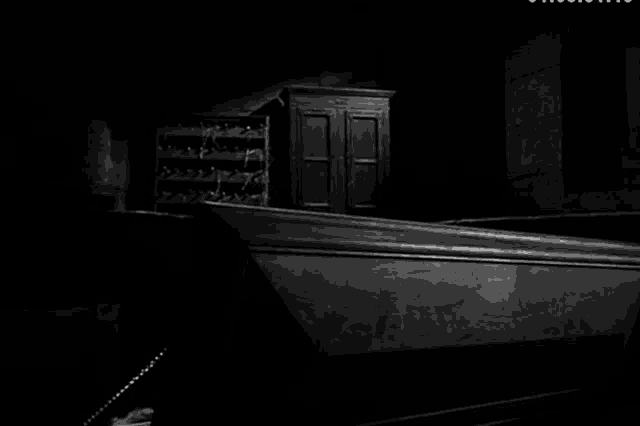 a black and white photo of a dark room