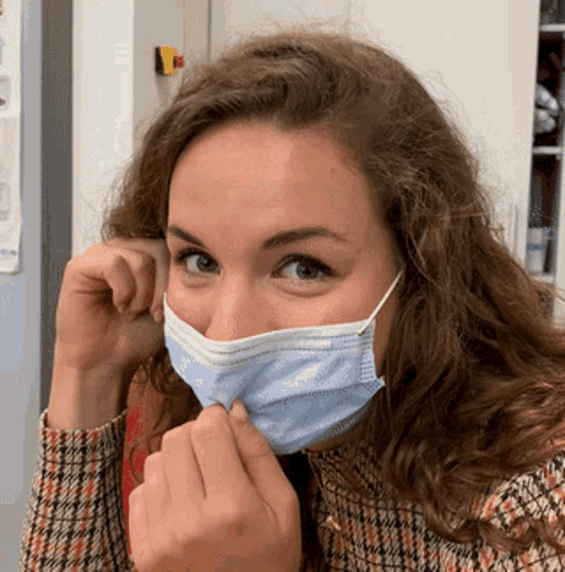 a woman wearing a face mask covering her nose