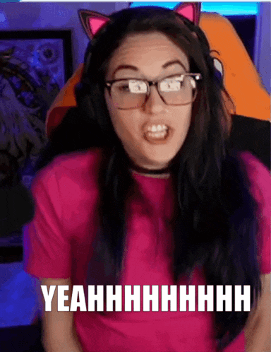 a woman wearing glasses and a pink shirt says yeahhhhhhhh