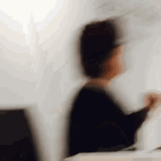 a blurry picture of a woman sitting at a desk