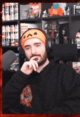 a man with a beard wearing headphones and a headband with a face on it