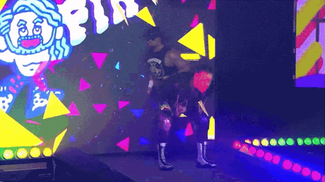 a wrestler is walking down a ramp in front of a colorful background that says ' sd '
