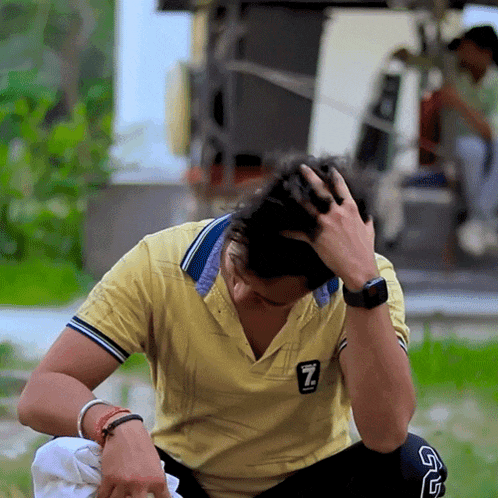 a man wearing a yellow shirt with the letter z on the front