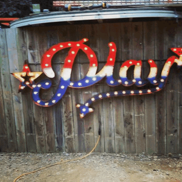 a red white and blue sign that says " play "