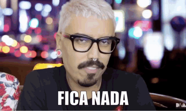 a man with glasses and a beard has the word fica nada on his face