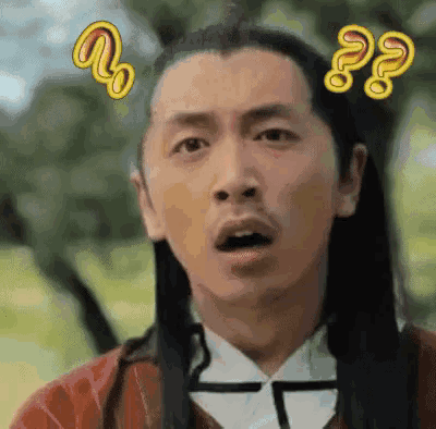 a man with long hair and a beard is making a surprised face with a question mark above his head .