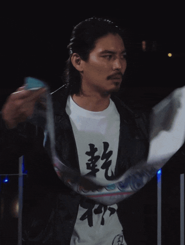 a man wearing a white shirt with chinese characters on it