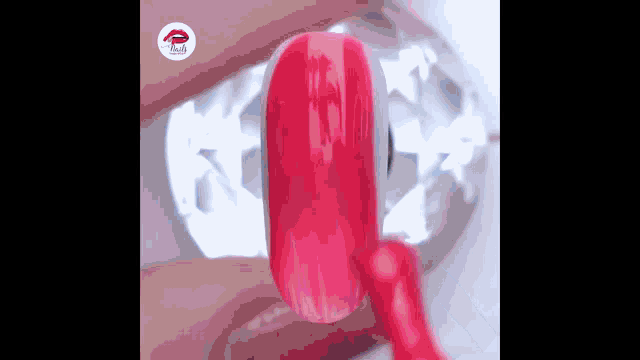 a close up of a person 's nail with a red nail polish