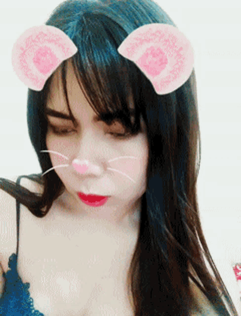 a close up of a woman wearing a cat ear filter