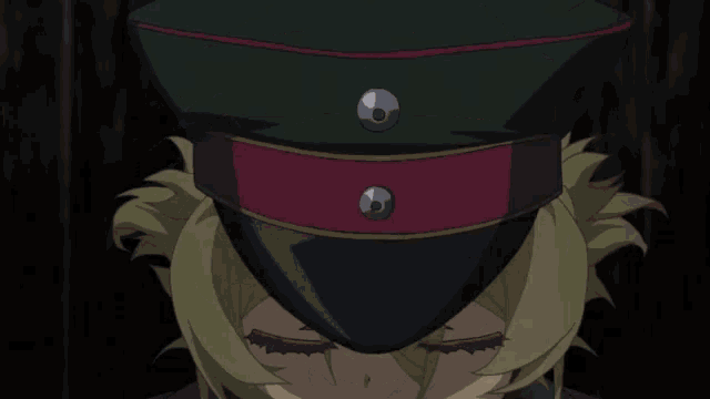 a close up of a person wearing a hat with a red band