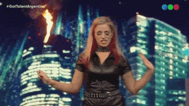 a woman in a black outfit is holding a torch in front of a city skyline with the hashtag #gottalentargentina