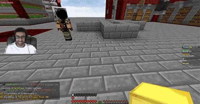 a man is sitting in a chair in a video game with a gold bar in the background .