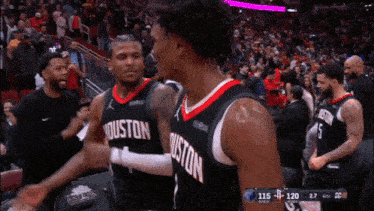 two basketball players from the houston rockets are hugging each other