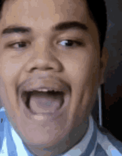 a man with his mouth open and his tongue out