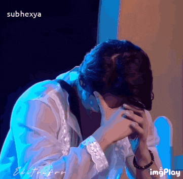 a person covering their face with their hands and the words subhexya on the bottom right