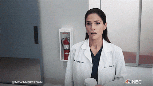 a woman in a lab coat is holding a cup of coffee with the hashtag #newamsterdam