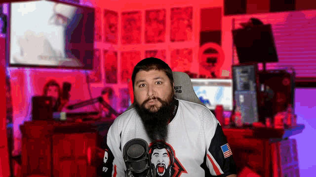 a man with a beard is standing in front of a microphone and wearing a shirt that says jet rab