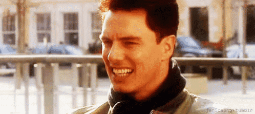 a close up of a man 's face smiling while wearing a jacket .