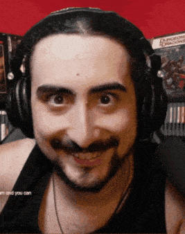 a man wearing headphones is smiling in front of a sign that says dungeons and dragons
