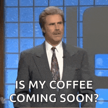 a man in a suit and tie is asking is my coffee coming soon ?