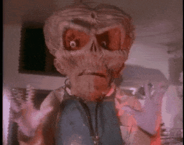 a close up of a cartoon character with a skull on his face