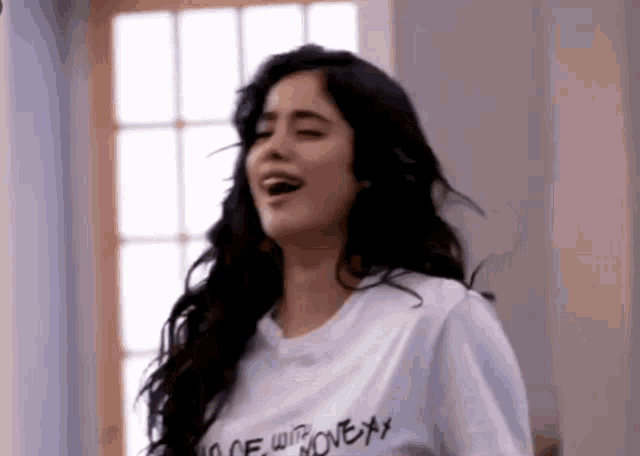 a woman wearing a white t-shirt with the word love on it .