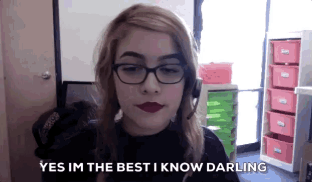 a woman wearing glasses and a headset is saying yes im the best i know darling