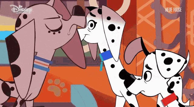 two dalmatian dogs standing next to each other with a disney logo on the bottom