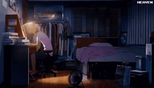 a man sits at a desk in a bedroom with the word heaven on the bottom right