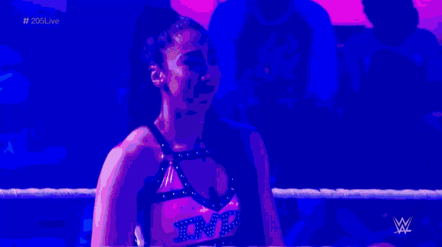 a woman in a wrestling ring with the letters tnt on her top