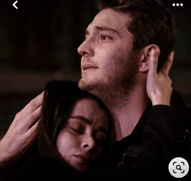 a man and a woman are hugging each other and the man is holding the woman 's head
