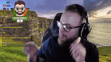 a man wearing glasses and headphones is playing a video game with justandy 89 behind him
