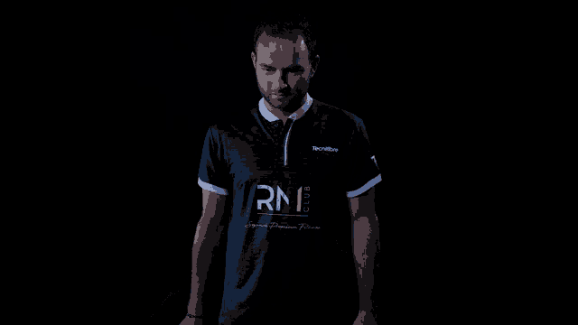a man wearing a shirt that says rn1 club on it