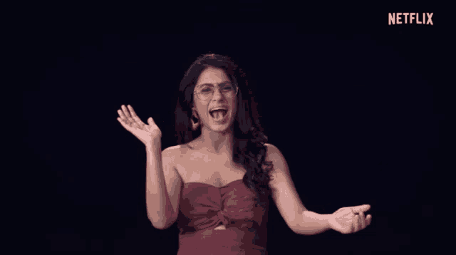 a woman in a red dress is making a funny face in front of a black background that says netflix