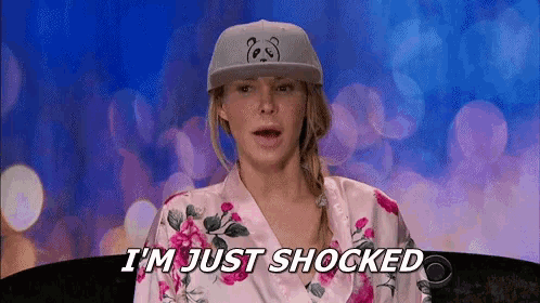 a woman wearing a hat and a robe is shocked and says `` i 'm just shocked '' .
