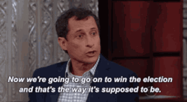 a man in a suit and plaid shirt is talking about the election