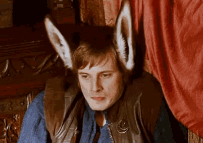 a man is wearing bunny ears on his head .