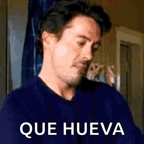 a man in a blue shirt says que hueva in white