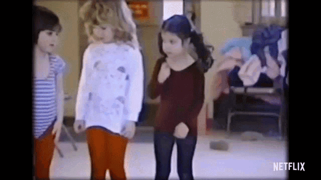 a group of young girls are dancing in a room with a netflix logo in the corner .